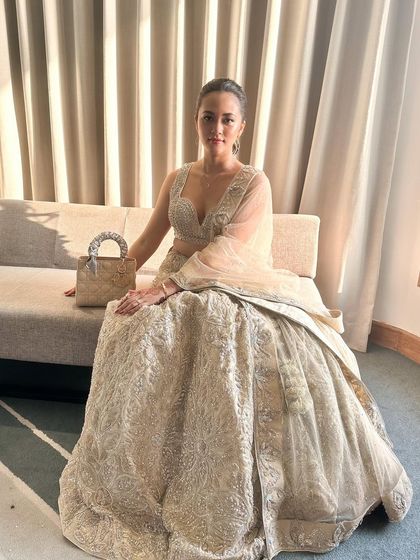 Exuding pure elegance in our champagne gold lehenga. This is a sophisticated choice for the modern bride who loves a bit of glamour.