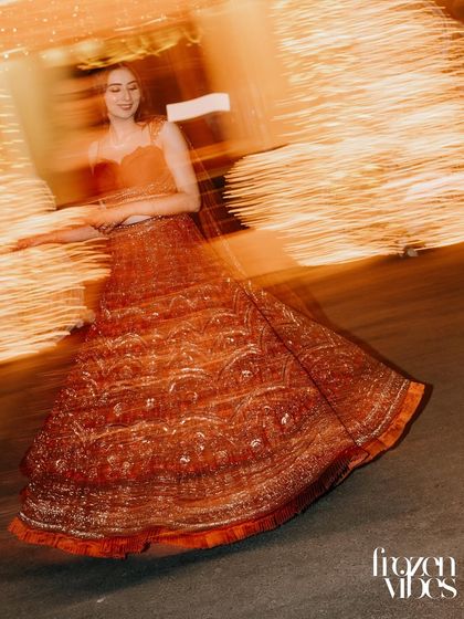 An artistic, motion-blur shot of the bride twirling. This technique beautifully captures the movement of her lehenga and the energy of the celebration.