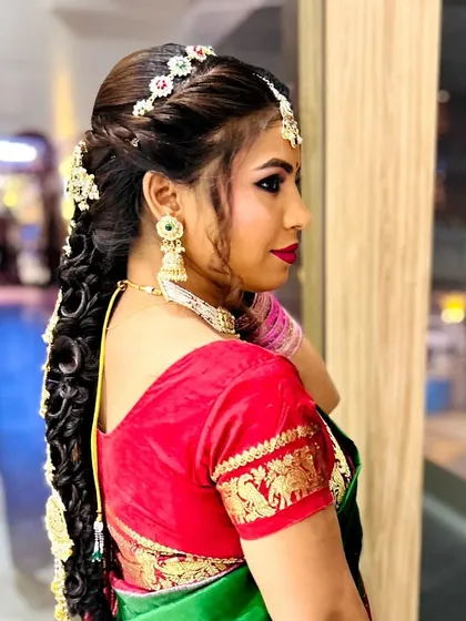 A side profile showing the intricate braid and the glowing makeup. This is a popular look for South Indian weddings.