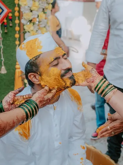 A close-up of the groom during his Haldi ceremony, as family members apply the turmeric paste. I capture the traditional aspects and the personal connections during these rituals.