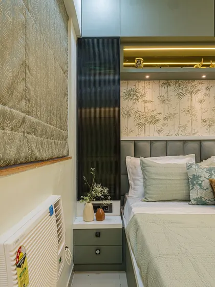 In compact bedrooms, every inch counts. Here, I integrated a sleek dressing table right next to the bed, using fluted panels and cove lighting to make it a stylish feature rather than just a functional piece.