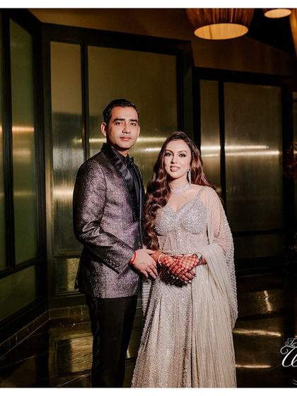 A classic, elegant portrait of the couple at their Sangeet in Goa, looking sharp and sophisticated.