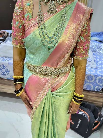 The full look of the reception drape for bride Lavanya. The saree is styled to highlight the intricate border and the delicate embroidery on her blouse, creating a cohesive and elegant bridal outfit.