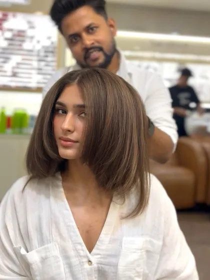 A beautiful brunette brown hair color transformation. The color is sleek and shiny, and the cut is modern and chic.