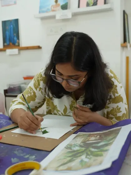 A student works on a watercolor painting during a short-term course. The small class sizes ensure personalized guidance and feedback.
