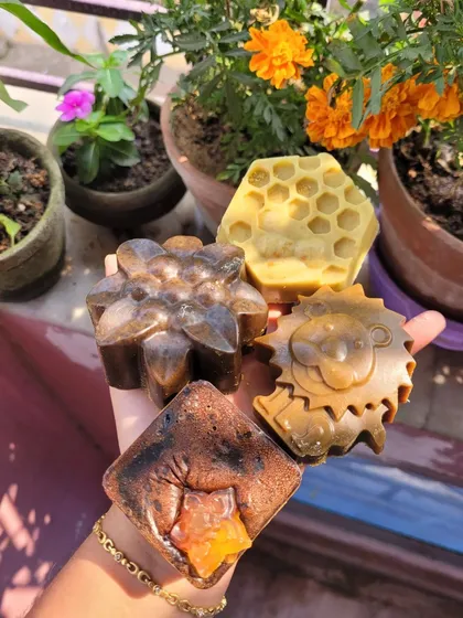 A handful of my artisanal soaps, showing the variety of shapes, colors, and textures I create.