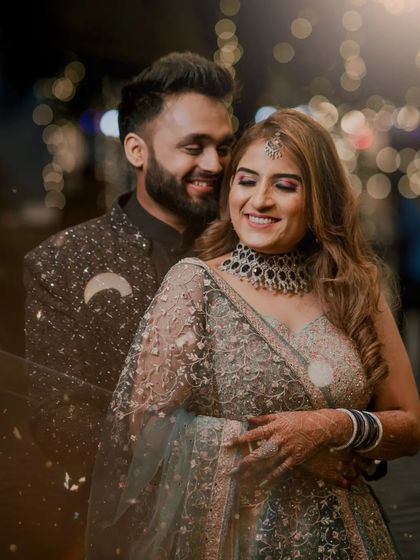A beautiful bokeh-filled portrait of the couple, their happy smiles glowing in the warm, blurry lights of the evening.