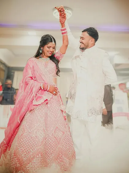 The energy and joy of a reception celebration. This shot captures the couple's first dance, surrounded by a dreamy fog effect, highlighting the movement, laughter, and pure fun of the party.