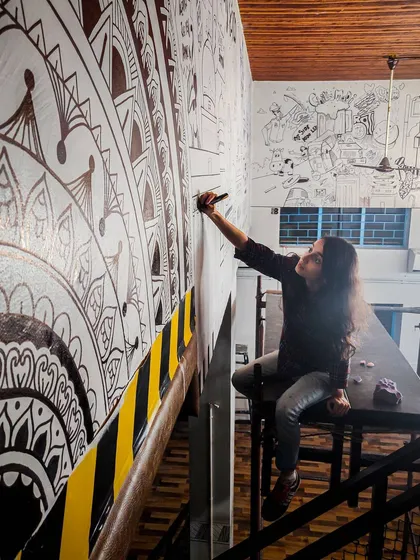 Bhavishya conquering her fear of heights to add details to this Bengaluru themed doodle. We use a mix of mandala patterns and city illustrations for a unique look.