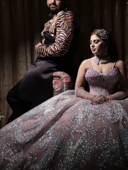 A stunning portrait of our client on her engagement day, seated like royalty in her magnificent silver and lavender ball gown. The gown's sparkle and volume create a powerful and glamorous statement, perfect for professional photos.