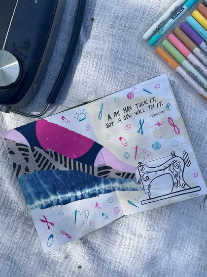 A sewing-themed journal page using fabric scraps and doodles. The quote reads, "A pin may tuck it, but a sew will fix it."