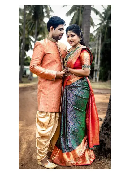 A full-length outdoor portrait of the traditionally dressed couple, a timeless memory from their engagement day.