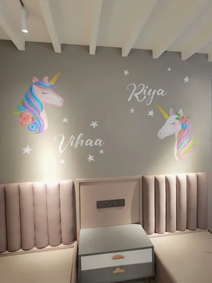 We created this magical unicorn-themed mural for a shared kids' bedroom. The design includes two distinct unicorns and personalized names, Vihaa and Riya, making the space truly special for its young residents.