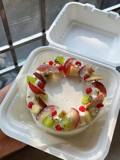 A beautiful fruit bento cake, ready for delivery. These personal-sized cakes are perfect for small celebrations and can be customized with your favorite flavors and designs. They are egg-free and can be made vegan.