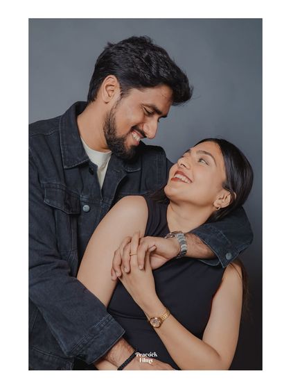 A classic pre-wedding studio portrait filled with warmth and affection. The groom's embrace and the couple's shared glance create a timeless image of their love.