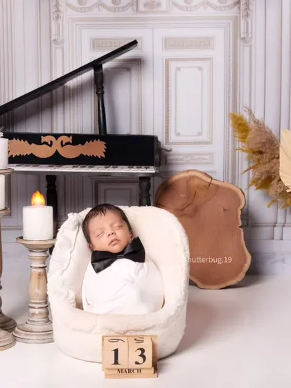 Another angle of our little maestro, with a wooden date block marking the special day of the photoshoot.