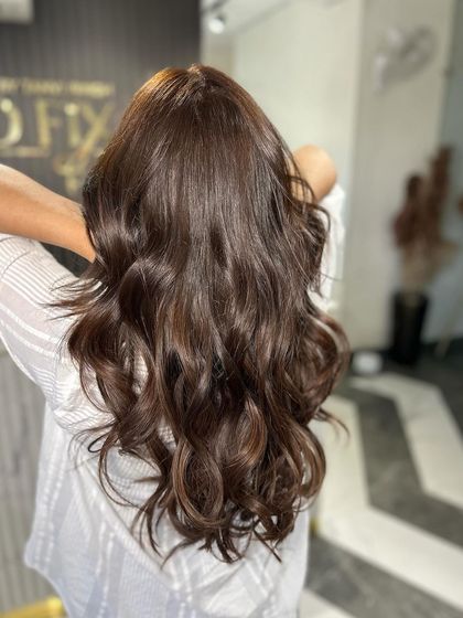 A simple yet elegant style with soft waves, showing off the hair's natural texture and shine.