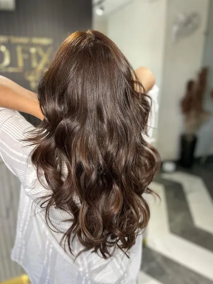 A simple yet elegant style with soft waves, showing off the hair's natural texture and shine.