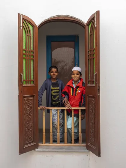 For me, architecture is about creating spaces for people. Here, two young residents of the Butterflies Resilience Centre look out from a 'jharokha' window made from upcycled shutters. These small moments of joy are the true measure of a successful building.