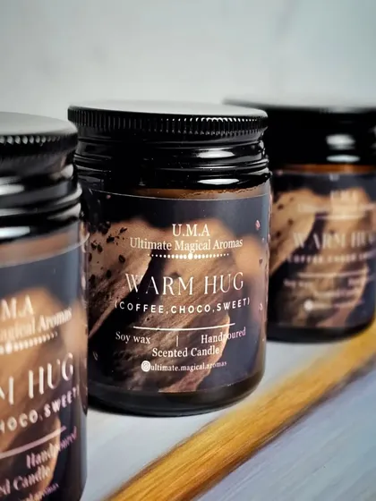 A trio of my 'Warm Hug' candles, which carry the essence of freshly ground coffee beans with a hint of choco. It's like a comforting wake-up call in a jar.