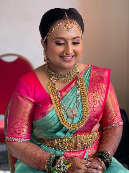 A lovely candid shot of Supritha. This shows how the makeup looks natural and beautiful even in moments of quiet reflection, enhancing her happiness on her special day.