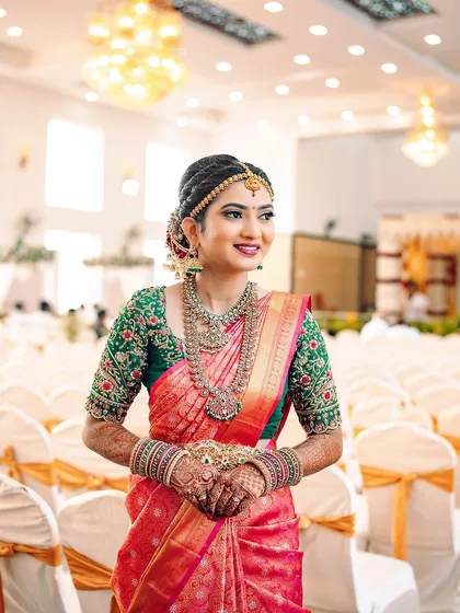 Rakshita in her second muhurtham look, featuring a beautiful pink and green saree. The makeup was touched up to perfectly match the new color palette.