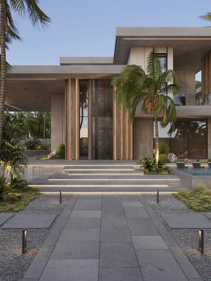 The grand entrance of the Arora residence, where our landscape design complements the modern architecture. The tiered steps are lined with integrated lighting, and the pathway is surrounded by manicured lawns, gravel beds, and statement palm trees.