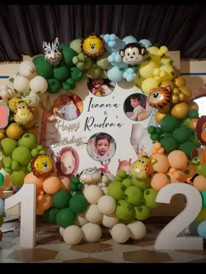 Let's go on a safari! This jungle-themed birthday is one of our favorites, featuring a full arch of green and earthy-toned balloons, adorable animal cutouts, and custom photo placements for the little adventurers.