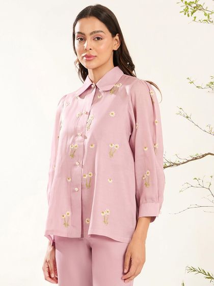A soft lilac co-ord set with a collared shirt adorned with dainty floral embroidery, perfect for a chic daytime look.