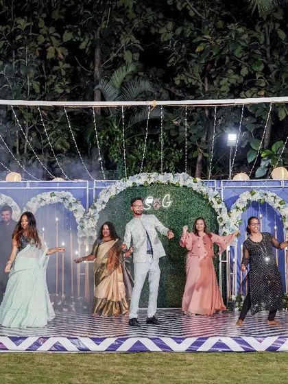 A group of friends performing on an outdoor stage. The choreography was designed to be fun, energetic, and perfect for a party atmosphere.