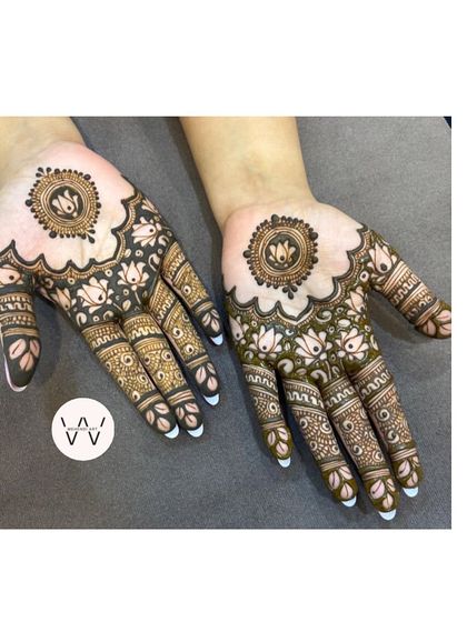 A beautiful henna design for the Teej festival, featuring lotus mandalas and intricately patterned fingers.