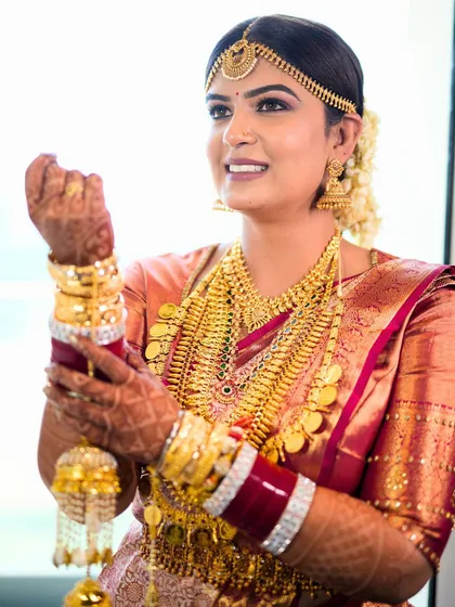 Adjusting her bangles, this candid shot shows the bride's happiness. Her makeup is soft and natural, allowing her to feel comfortable and beautiful.