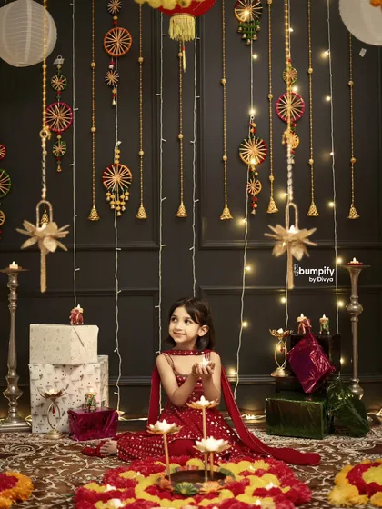 The wonder in her eyes says it all. Here, I wanted to capture a quiet moment of a little girl mesmerized by the diyas during our Diwali themed shoot, surrounded by a backdrop of lights and festive decor.