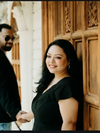 A playful and romantic pre-wedding photo. The groom leads his partner by the hand, with a smile that shows their excitement and happiness.