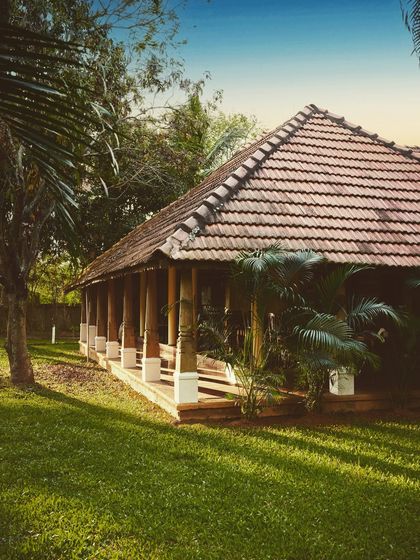A view of our restaurant building, designed in traditional Kerala style with an open-air layout. It is surrounded by nature, allowing you to dine in a peaceful and refreshing environment.