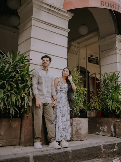 Looking up at the grand architecture of Mumbai and the future they're building together. A beautiful, candid moment from their city pre-wedding shoot.