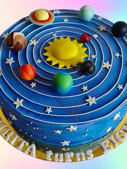 A solar system cake for an 8th birthday. This educational and fun design features all the planets orbiting the sun on a deep blue whipped cream cake.