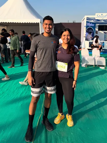 A coach and athlete duo posing after a successful run. The mentorship within our group is a key part of our success.