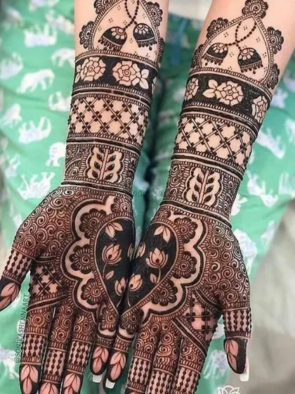 This design shows my modern approach to bridal henna. By using negative space and clean floral patterns, the two hands come together to form a beautiful heart, creating a chic and contemporary look that is both elegant and meaningful.