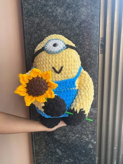 A custom order for a very soft and squishy Minion, holding a single crocheted sunflower. I used a plush, thick yarn for this to make it extra huggable.