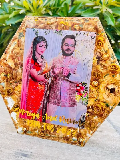 An 8-inch hexagon block filled with preserved golden-yellow roses. The couple's photo and names are set against a backdrop of their wedding flowers.