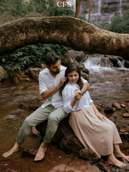 A tender moment where he gently tucks her hair back, with the waterfall as a soft backdrop. It's these small, unscripted gestures that I love to capture.