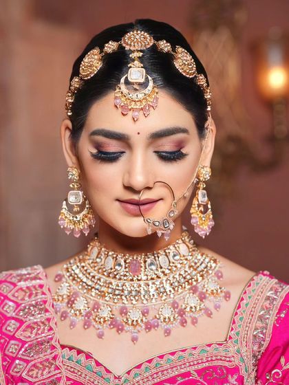 A close-up of a bride with a soft pink makeup look, featuring beautiful shimmery eyes and a matching lip color.