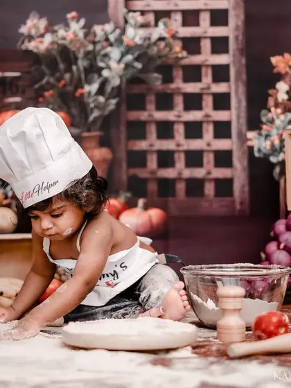 Let's get creative with a flour smash. This kitchen-themed baby shoot is a playful alternative to a cake smash, where your little one can explore new textures in a fun and rustic setup, resulting in adorable, action-filled photos.