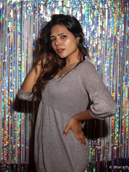 Using a tinsel backdrop in the studio for a fun, party vibe. This is a great option for celebratory or high-energy portraits.
