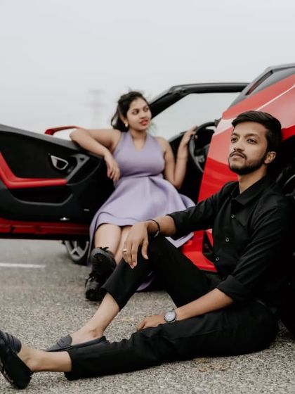 A cool, cinematic pose with a red Lamborghini, capturing a modern and edgy vibe for a pre-wedding shoot in Dubai.