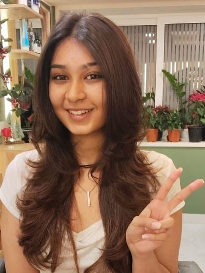 Peace and happiness after a great haircut. She is clearly thrilled with her fresh new look.