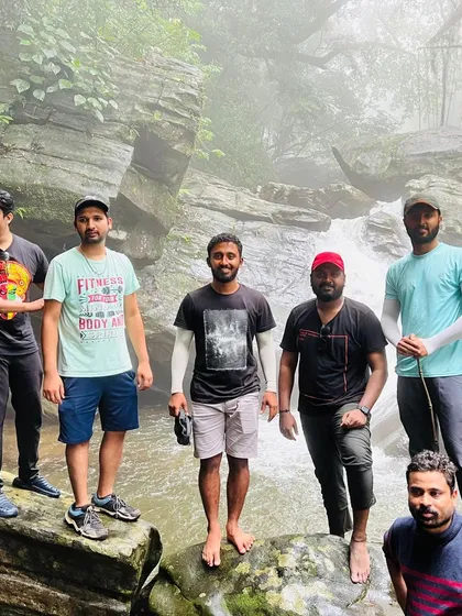 A group posing by a stream on the Bandaje trek trail.