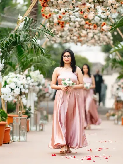The bridesmaids make their way down the beautifully decorated aisle, setting the stage for the bride's grand entrance.