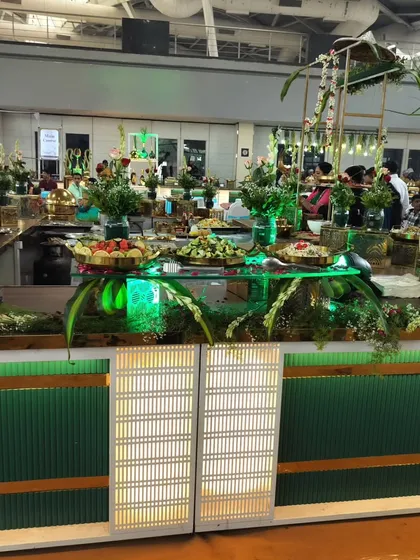 A wide view of a grand indoor buffet setup, showcasing my ability to handle large-scale events with custom lighting and decor that transforms any venue.